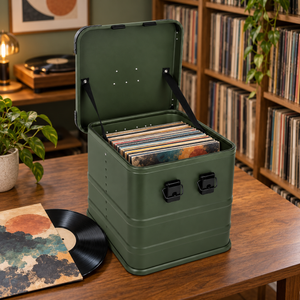 Olive green aluminum record storage box holding one row of upright 12-inch LP jackets in a home record library