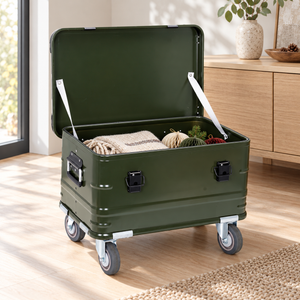 Open green aluminum rolling trunk holding example seasonal decorations and a folded throw; contents not included