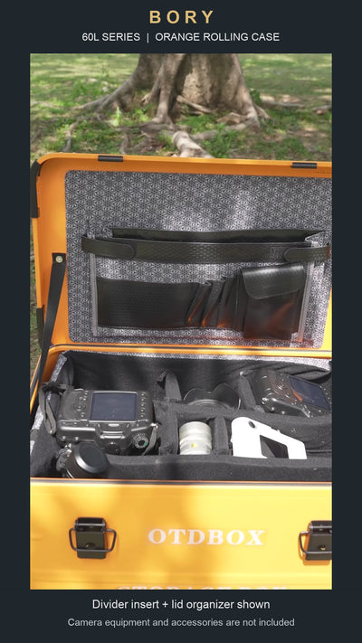 Orange 60L-series aluminum rolling case with padded dividers and lid organizer; camera equipment shown is not included